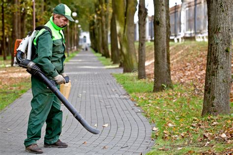 Using leaf blowers and vacuums. Man with leaf blower stock photo. Image of autumnal ...