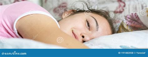 Smiling Teenage Brunette Wakes Up And Looks Straight Stock Photo