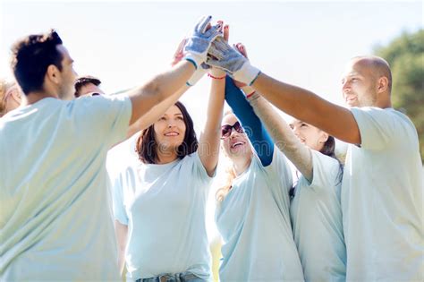 Group Of Volunteers Making High Five In Park Stock Image Image Of