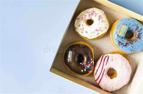 Fresh Donuts With Colored Glaze In A Cardboard Box Top View Colorful