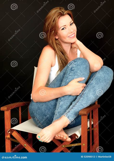 Beautiful Happy Relaxed Young Woman Sitting In A Chair Stock Photo