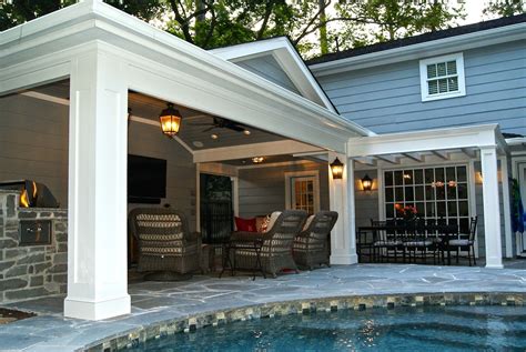 An Outdoor Living Area Next To A Swimming Pool