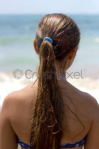 Tanned Girl In Bikini With Long Hair Looking To The Stock Photo