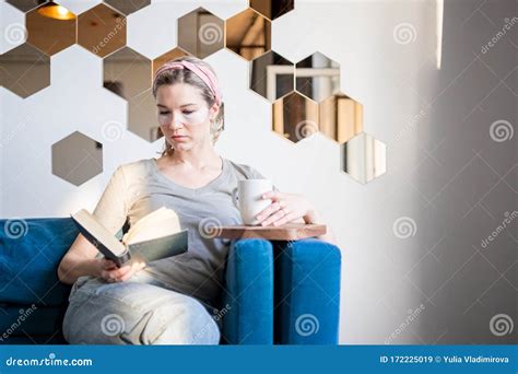 Young Attractive Woman Sitting And Reading Book Drinking Coffee Self Care Concept Stock Image
