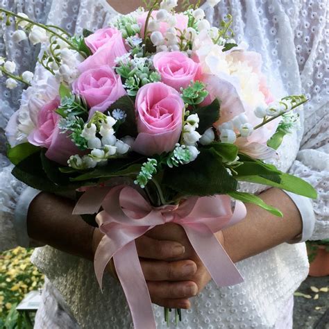 An Artificial Wedding Bouquet Of Pink Rose Peony And Lily Of The Valley