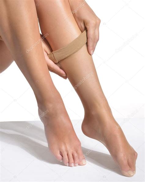 Close Up Of A Woman Pulling On A Set Of Silk Stockings Stock Photo By