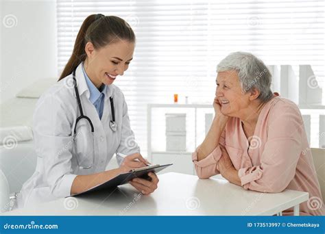 Doctor Examining Senior Patient In Office Stock Image Image Of Mature