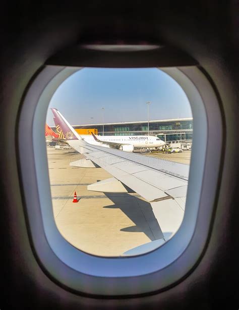 Aircraft Parked At Airport Through Window At Morning From Flat Angle