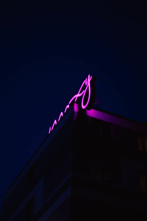 Download Purple Neon Sign On Roof Wallpaper