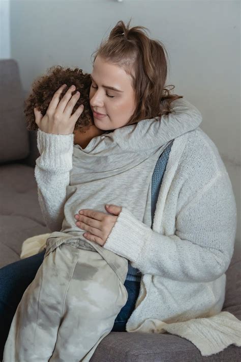 Loving Mother Comforting Crying Son On Couch · Free Stock Photo