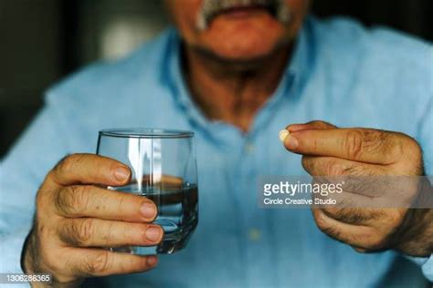 man popping pills photos and premium high res pictures getty images