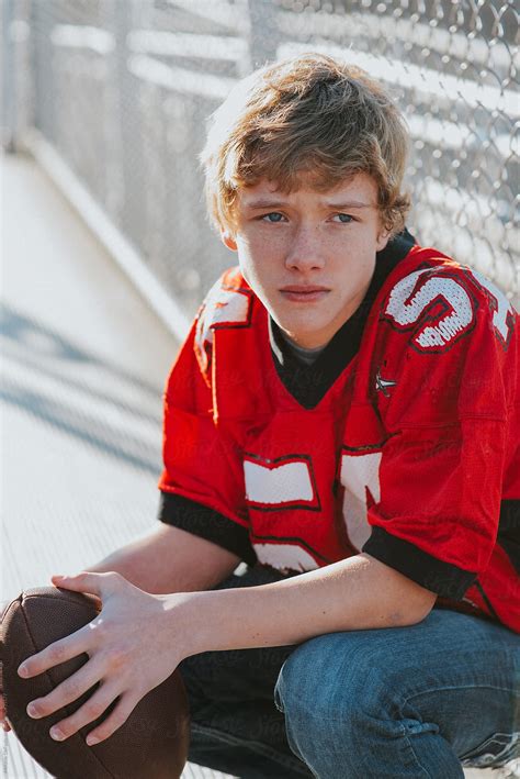 Teen Football Player By Stocksy Contributor Melanie Defazio Stocksy