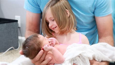Big Sister Holding Newborn Baby Brother For The First Time Sweetest