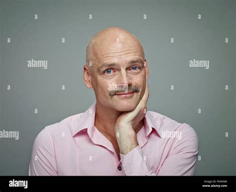Portrait Of Bald Man With Moustache Wearing Pink Shirt Stock Photo Alamy