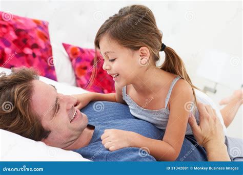 Father And Daughter Lying In Bed Together Stock Image Image 31342881