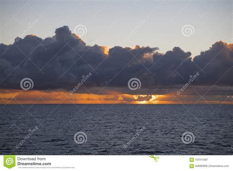 Sunset Behind Dark Clouds Over Ocean Stock Image Image Of Nature