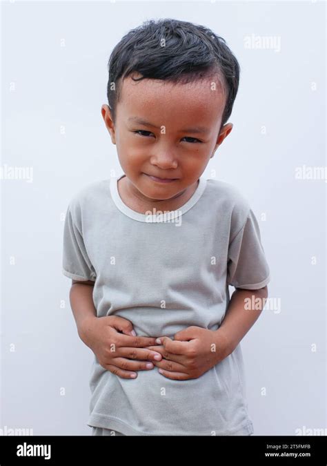 Portrait Of A Little Asian Boy Suffering From Stomach Ache Isolated On