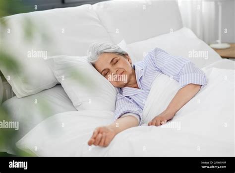 Senior Woman Sleeping In Bed At Home Bedroom Stock Photo Alamy