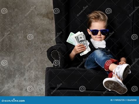 Serious Arrogant Rich Kid Boy Millionaire Sits With A Bundle Of Money