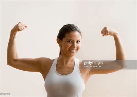 Hispanic Woman Flexing Biceps Muscles Photo Getty Images