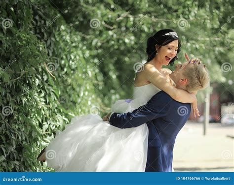 Funny Bride And Groom Embracing On The Street Stock Photo Image Of