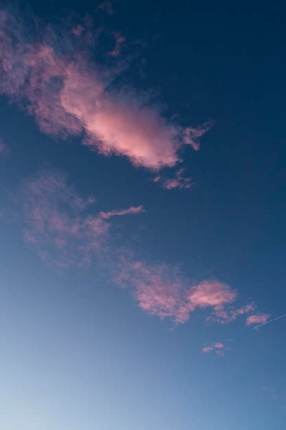 Premium Photo Pink Clouds In Bright To Dark Blue Sky