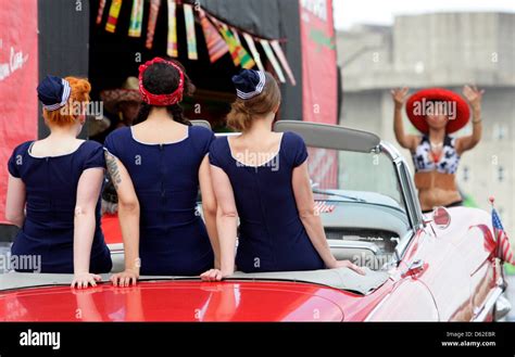 An American Convertible With Three Burlesque Dancers Drives To The