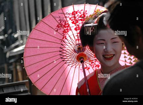 A Maiko Trainee Geisha Talks To A Man In The Gion District In Kyoto
