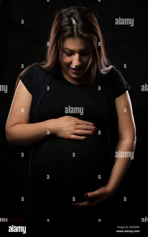 Young Brunette Woman Holding Her Pregnant Belly Studio Light Used