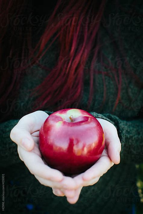 A Redheaded Woman Holding A Red Apple By Howl Stocksy United