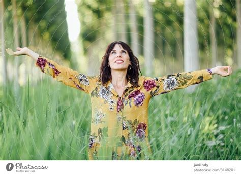 Woman Opening Arms While Enjoys Nature In A Tree Forest A Royalty