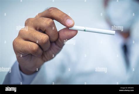 Doctor In Uniform Holding A Cigarette On White Background Quit