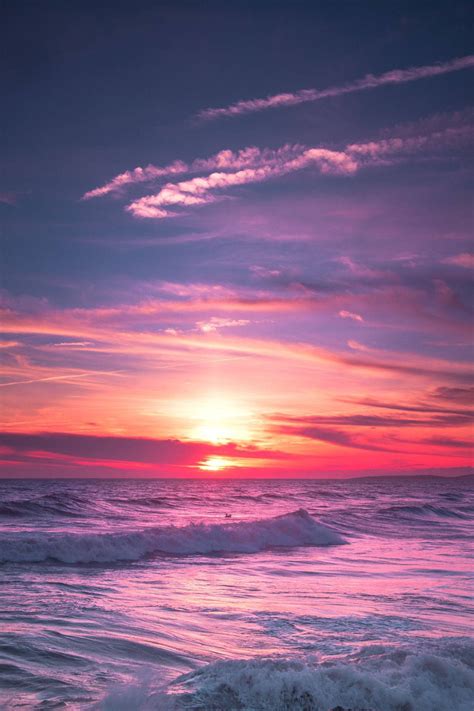 Download Purple Aesthetic Sunset Sky Over Ocean Waves Wallpaper