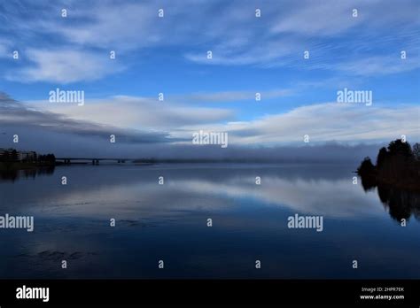 Sky And Clouds Reflection On Calm Lake Water Blue Autumns Evening With