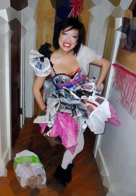 A Woman Dressed Up As A Fairy With Lots Of Paper On Her Chest And Arms