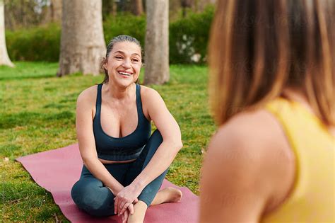Mature Woman Talking With A Yoga Classmate By Stocksy Contributor Ivan Gener Stocksy