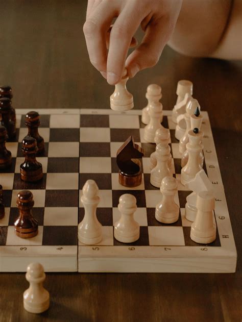 Person Playing Chess Game On Chess Board · Free Stock Photo