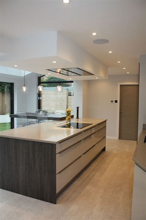 Free quotations and site visits are available, please call us for more information. Kuhlmann Gloss Cashmere kitchen, with dark wood panels ...