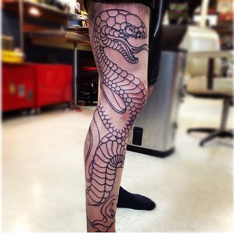 Check out our snake tattoo selection for the very best in unique or custom, handmade pieces from our tattooing shops. Awesome black snake tattoo on leg - | TattooMagz › Tattoo Designs / Ink Works / Body Arts Gallery