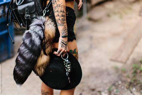 A Woman Wearing Two Furry Fox Tails On Her Waist By Stocksy