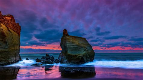 Rocks Stones On Ocean Waves Beach Sand Reflection Under Light Purple