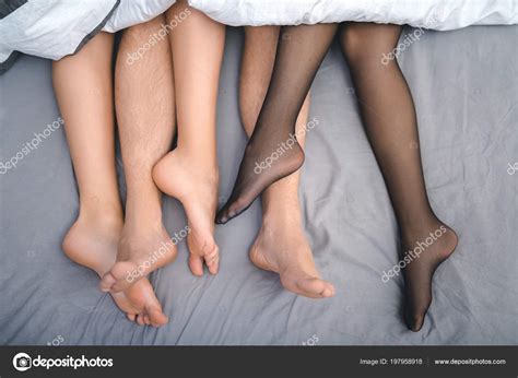 Close Up Feet Of Trio Making Love In Bedroom Stock Photo By Stockveres