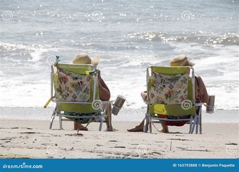 People Relaxing By The Beach In Beach Chairs Stock Photo Image Of Chair Vacation