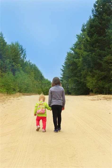 Little Tourists Go On Road Girls Travellers Walk On The Forest Path