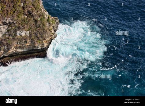 Dramatic View Of Ocean Waves Crashing Around Rocks On Nusa Penida