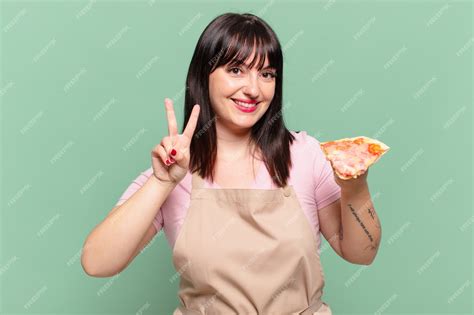 Premium Photo Pretty Chef Woman Celebrating Successful A Victory And Holding A Pizza