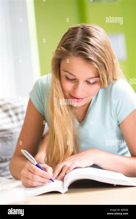 Female Student Doing Homework In Library Stock Photo Alamy