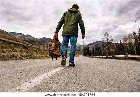 Man Backpack Hand Walking Alone Down Stock Photo Edit Now 406701244