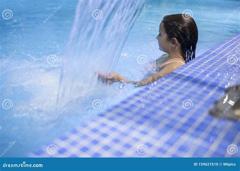 7 Years Little Girl Enjoying Waterfall Jets At Indoor Pool Spa Stock