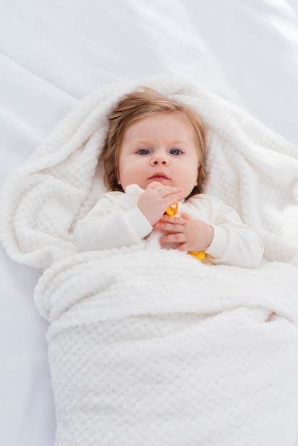 Flat Lay Of Baby In White Blanket Free Photo